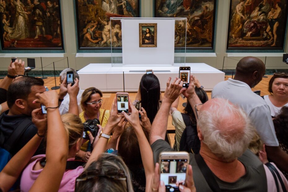 People with smartphones photographing the Mona Lisa